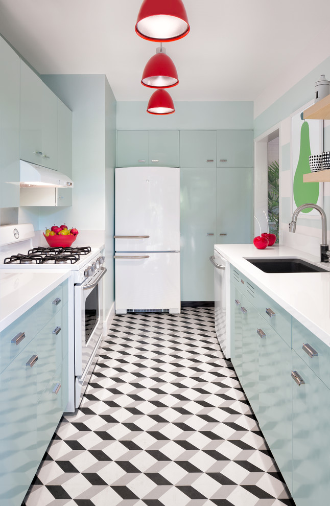 This is an example of a small midcentury galley separate kitchen in Miami with an undermount sink, flat-panel cabinets, blue cabinets, quartzite benchtops, multi-coloured splashback, white appliances, porcelain floors and no island.