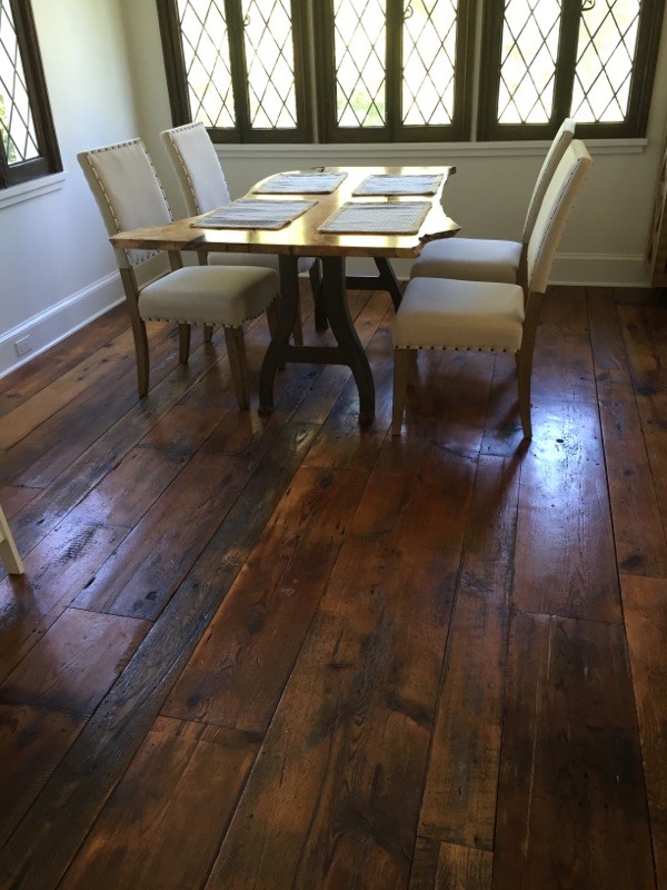 Example of a small classic dark wood floor and brown floor enclosed dining room design in New York with beige walls and no fireplace