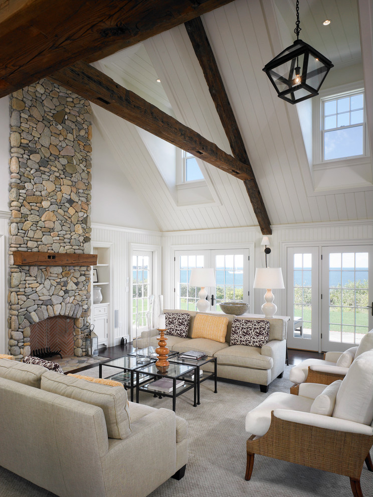 Large beach style open concept living room in Boston with white walls, a standard fireplace, a stone fireplace surround and dark hardwood floors.