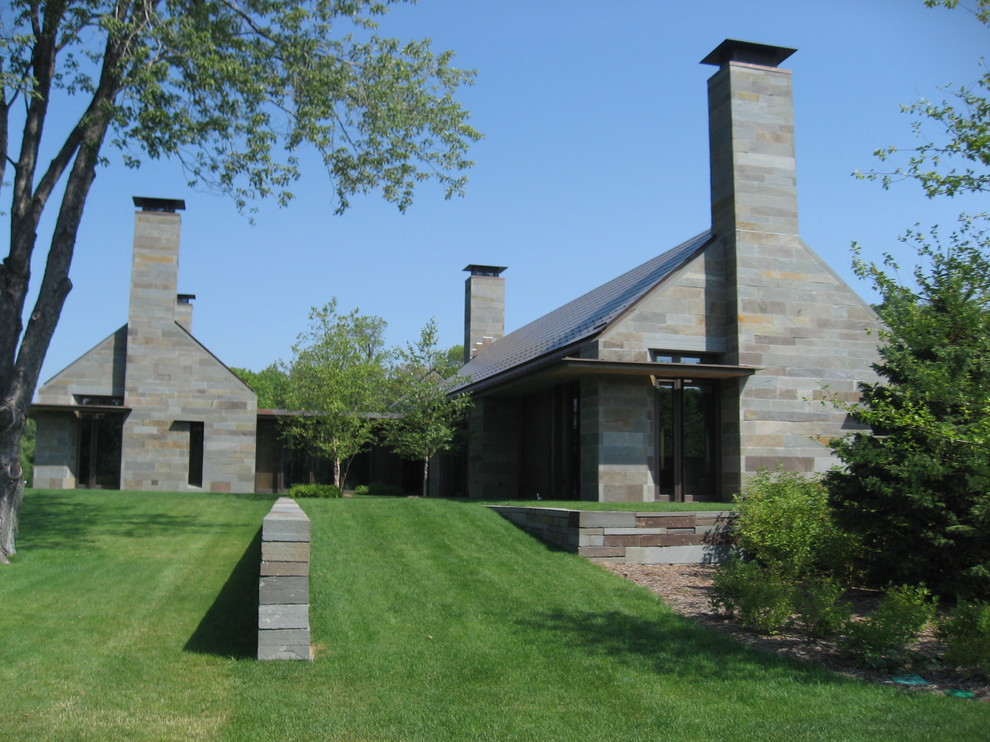 Inspiration for a contemporary exterior in Minneapolis with stone veneer and a gable roof.