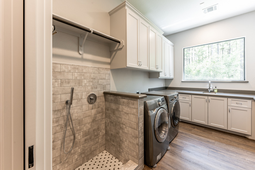 Inspiration for a large contemporary galley dedicated laundry room remodel in Houston with an undermount sink and a side-by-side washer/dryer