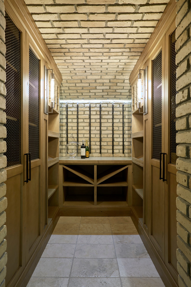 Inspiration for a mid-sized transitional wine cellar in Toronto with limestone floors and display racks.
