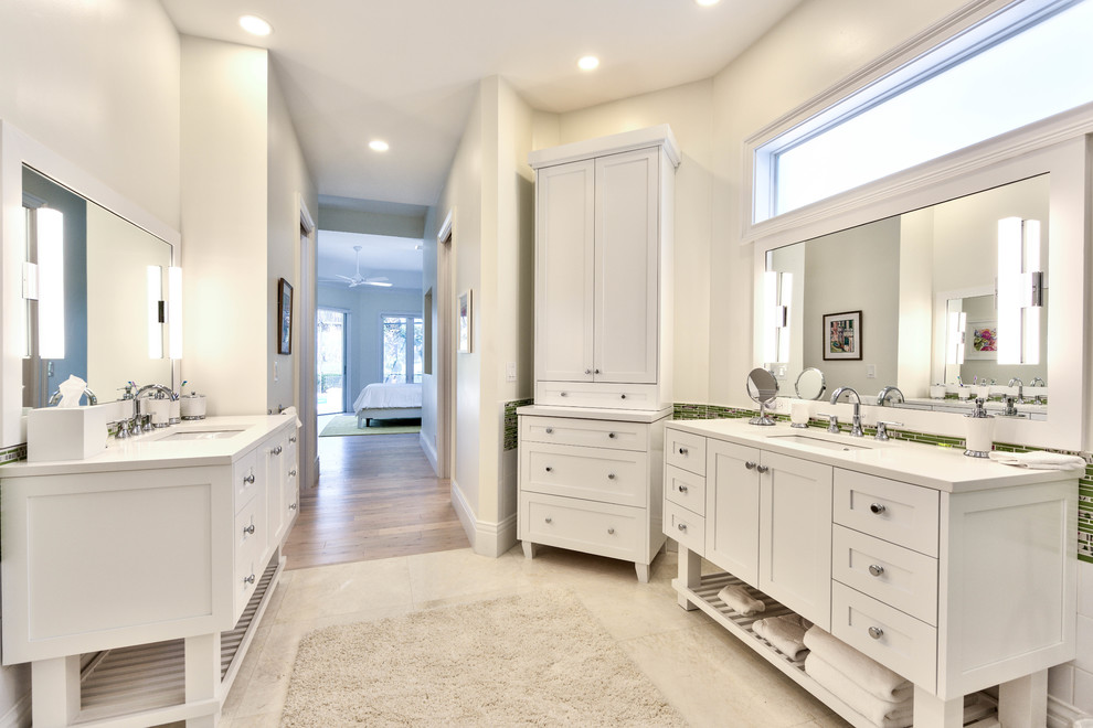 Photo of a large transitional master bathroom in Miami with white cabinets, engineered quartz benchtops, shaker cabinets, a freestanding tub, a curbless shower, multi-coloured tile, matchstick tile, grey walls, travertine floors, an undermount sink, beige floor, an open shower and white benchtops.