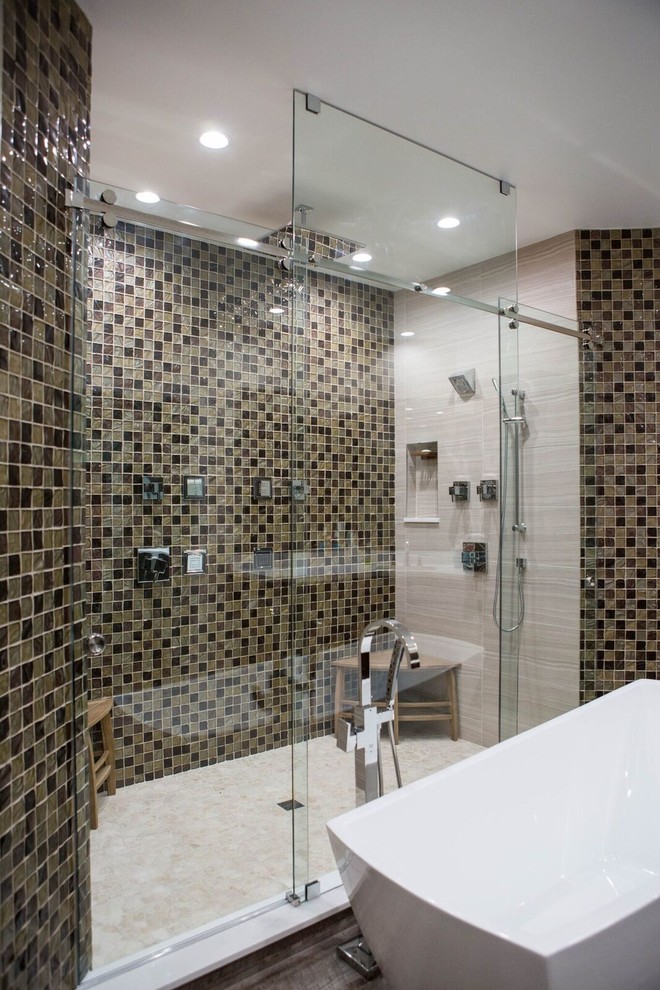 This is an example of a large contemporary master bathroom in Miami with a freestanding tub, an alcove shower, a two-piece toilet, beige tile, brown tile, mosaic tile, beige walls and dark hardwood floors.