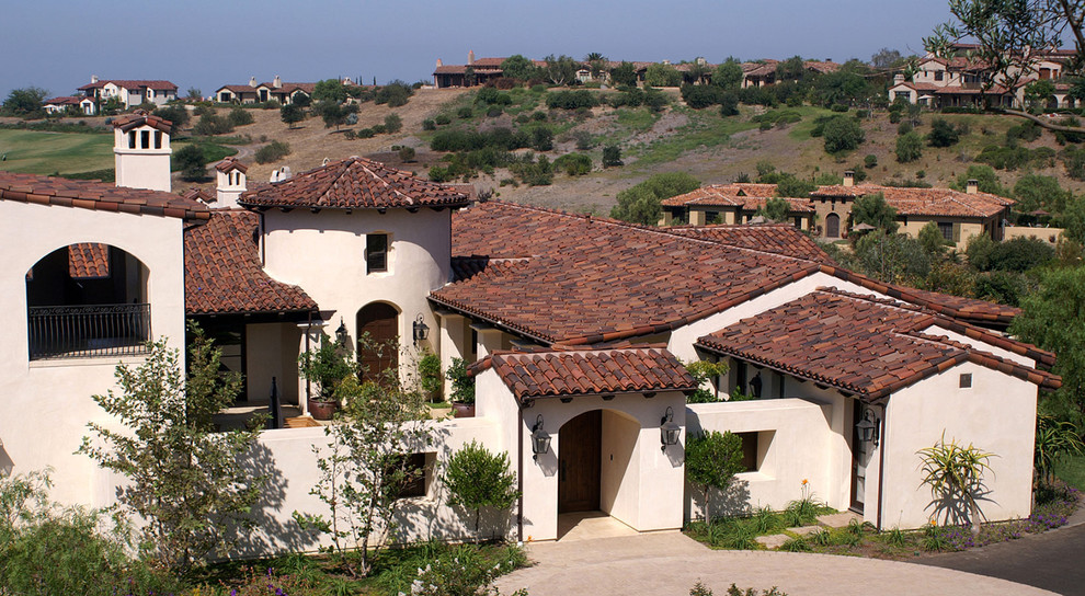 Design ideas for a mediterranean one-storey exterior in San Diego with a tile roof.