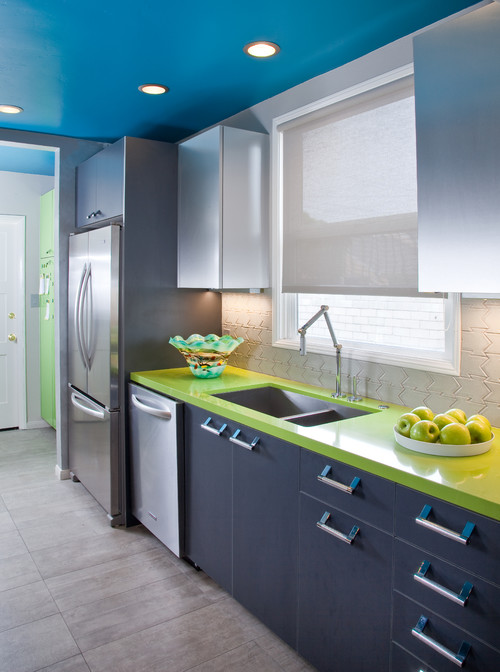 Colorful modern kitchen with stainless steel cabinets and bright green countertop accents