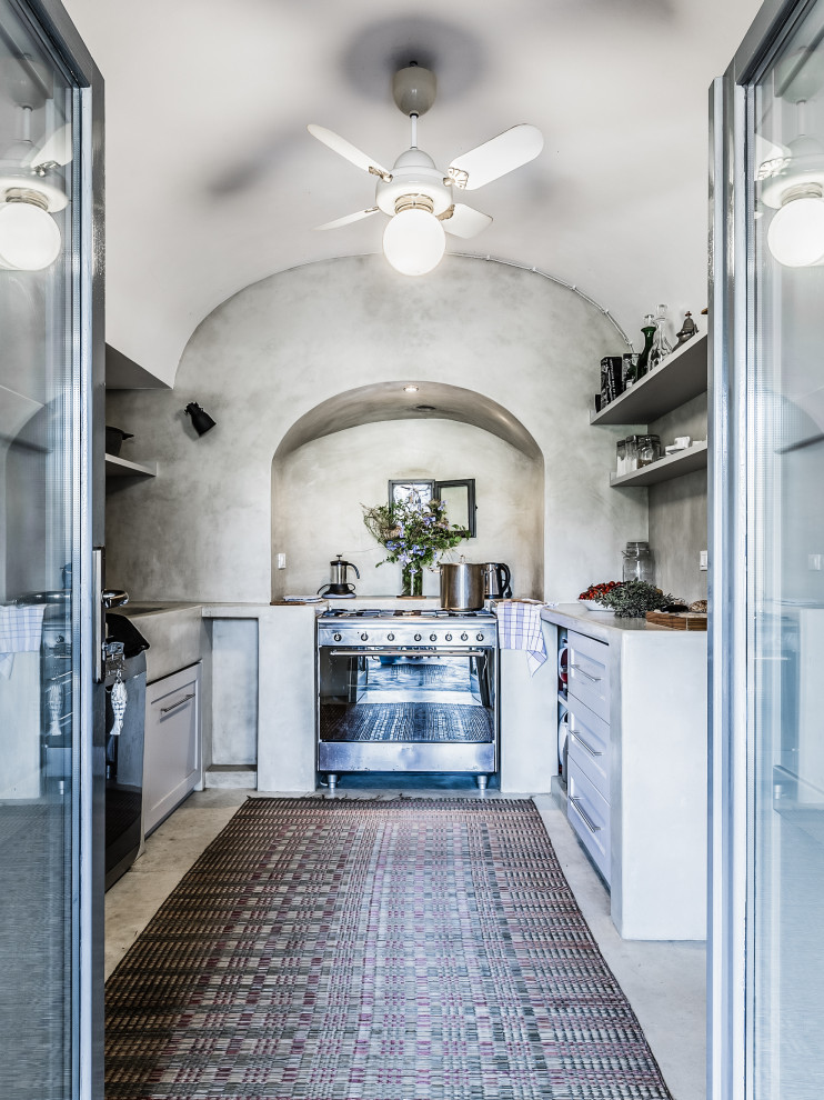 Mid-sized mediterranean u-shaped kitchen in Other with an integrated sink, shaker cabinets, white cabinets, grey splashback, stainless steel appliances, no island, grey floor and grey benchtop.