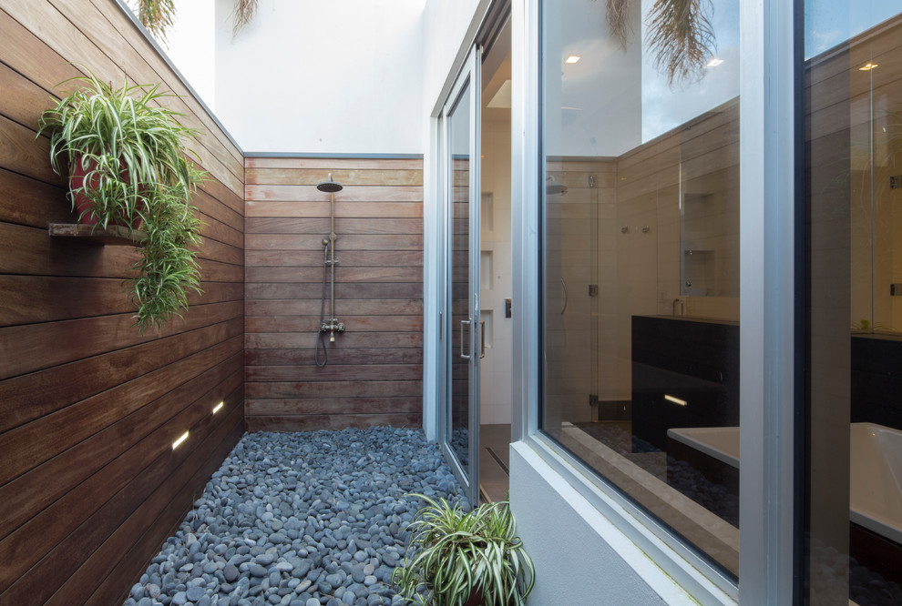 Photo of a contemporary patio in Miami with an outdoor shower and no cover.