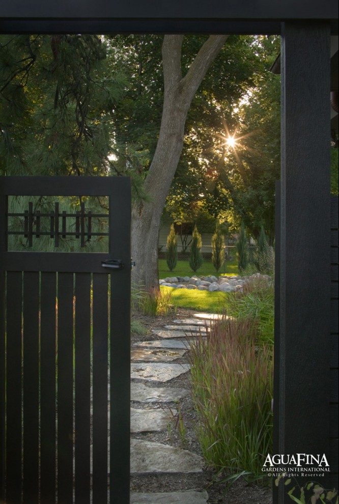 Design ideas for a mid-sized modern backyard stone garden path in Detroit.