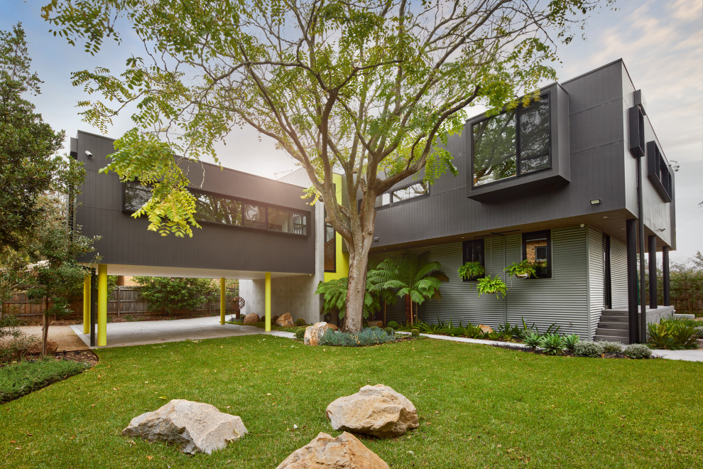 Inspiration for a large contemporary two-storey black house exterior in Melbourne.
