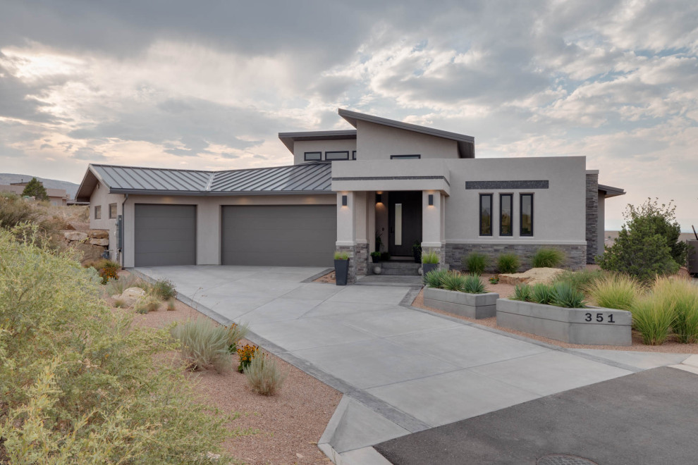 Mid-sized contemporary beige one-story mixed siding flat roof idea with a metal roof