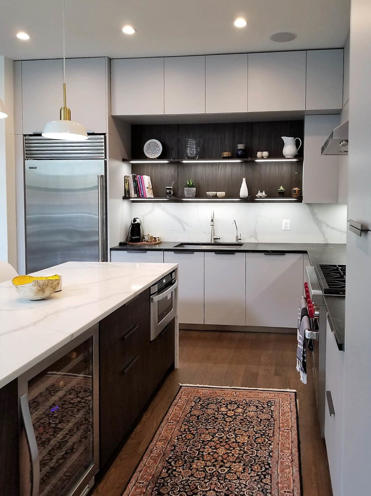 Inspiration for a mid-sized modern l-shaped open plan kitchen in New York with an undermount sink, flat-panel cabinets, grey cabinets, quartz benchtops, white splashback, stone slab splashback, stainless steel appliances, dark hardwood floors, with island, brown floor and multi-coloured benchtop.