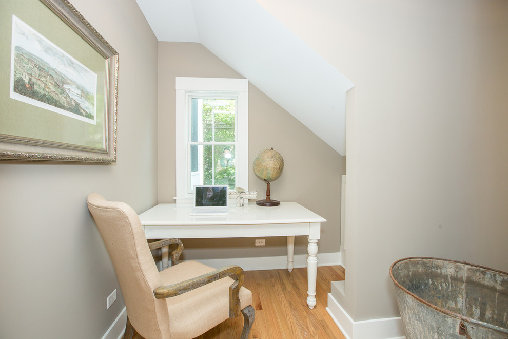 Photo of a small country study room in Chicago with light hardwood floors, a freestanding desk, grey walls and no fireplace.