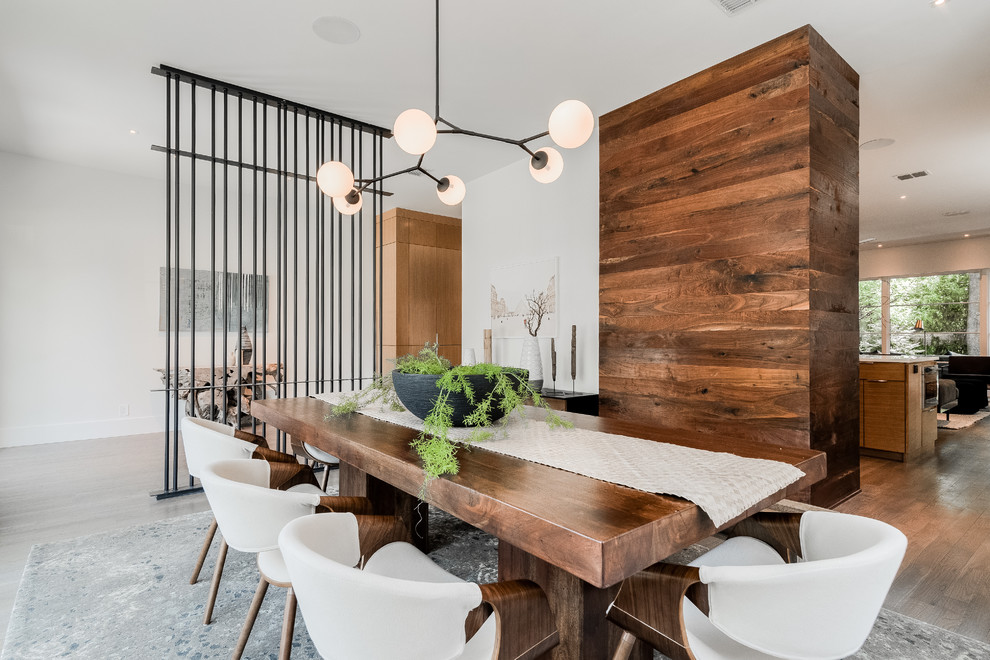 Inspiration for a mid-sized contemporary separate dining room in Dallas with white walls, light hardwood floors and no fireplace.