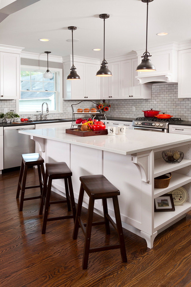 Design ideas for a traditional l-shaped eat-in kitchen in Minneapolis with an undermount sink, shaker cabinets, granite benchtops, white splashback, subway tile splashback and stainless steel appliances.