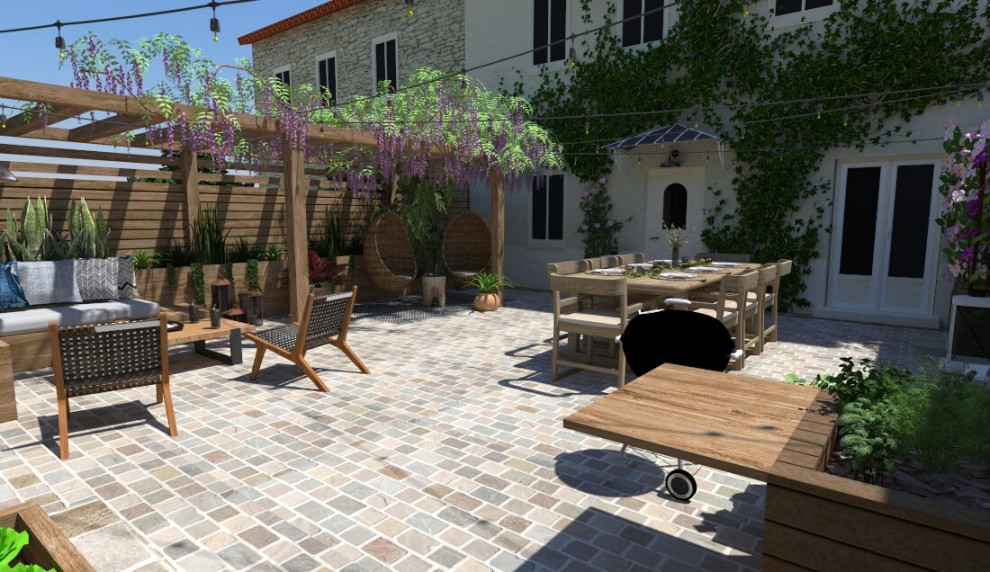 Immagine di un grande patio o portico country dietro casa con pavimentazioni in pietra naturale e una pergola