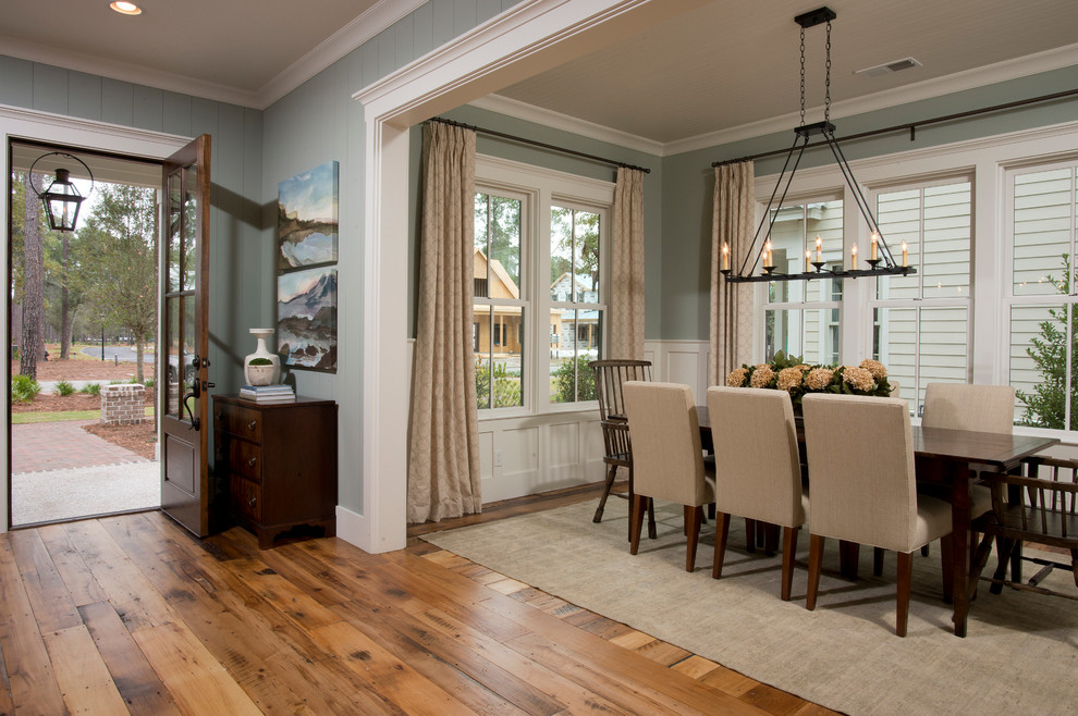 Photo of a mid-sized traditional open plan dining in Charleston with medium hardwood floors, blue walls, no fireplace and brown floor.