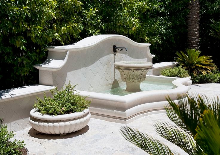 Inspiration for an expansive traditional courtyard patio in Phoenix with a water feature, natural stone pavers and no cover.