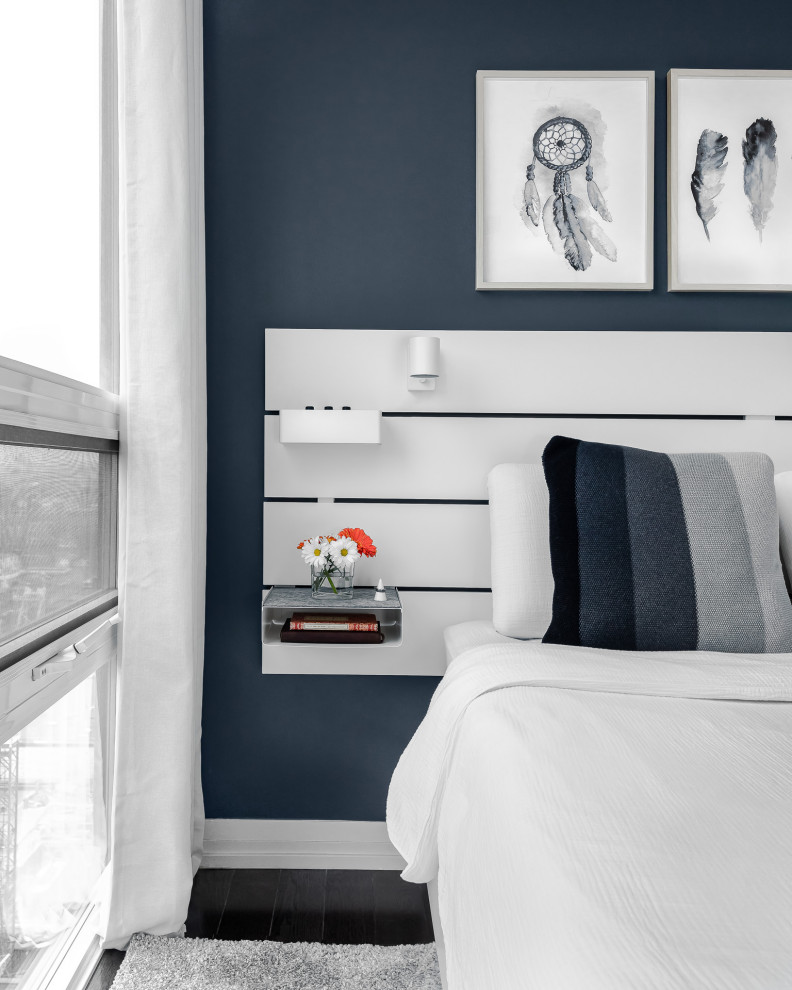 Mid-sized contemporary master bedroom in Toronto with blue walls, dark hardwood floors and black floor.