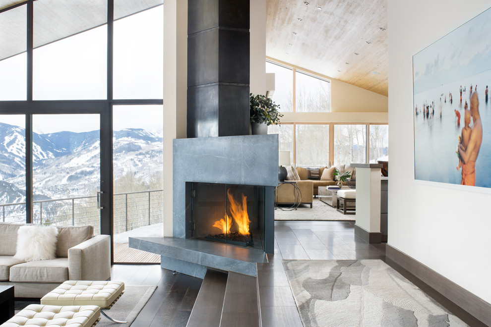 Photo of a contemporary formal open concept living room in Denver with white walls, dark hardwood floors and a stone fireplace surround.