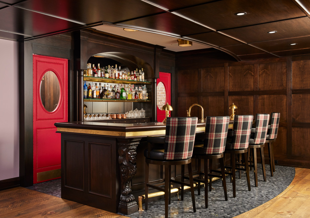 Photo of a traditional galley seated home bar in Minneapolis with recessed-panel cabinets, dark wood cabinets, wood benchtops, marble floors and grey floor.