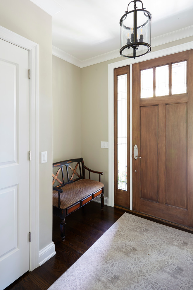 Design ideas for a large country front door in Chicago with beige walls, dark hardwood floors, a single front door and a medium wood front door.