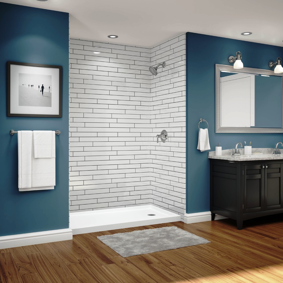 Photo of a traditional bathroom in Milwaukee with raised-panel cabinets, dark wood cabinets, an open shower, blue walls, bamboo floors, a drop-in sink and an open shower.