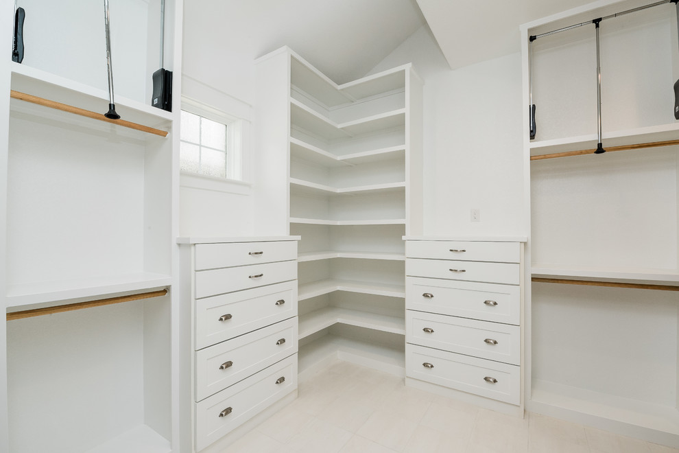 Mid-sized country gender-neutral dressing room in Dallas with shaker cabinets, white cabinets, ceramic floors and white floor.