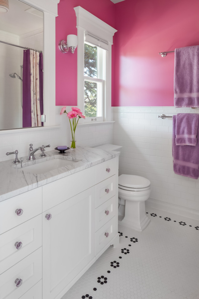 Inspiration for a mid-sized arts and crafts kids bathroom in Seattle with shaker cabinets, white cabinets, a freestanding tub, a shower/bathtub combo, a two-piece toilet, white tile, ceramic tile, blue walls, marble floors, an undermount sink, marble benchtops, white floor, a shower curtain, white benchtops, a niche, a single vanity and a freestanding vanity.