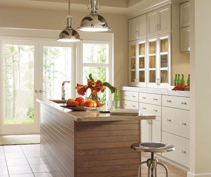 Eat-in kitchen - mid-sized transitional single-wall ceramic tile eat-in kitchen idea in Chicago with an undermount sink, recessed-panel cabinets, white cabinets, beige backsplash, stone tile backsplash, stainless steel appliances and an island