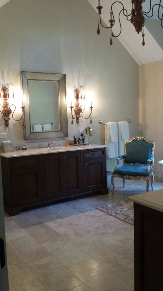 Transitional master travertine floor freestanding bathtub photo in Chicago with recessed-panel cabinets, dark wood cabinets and beige walls