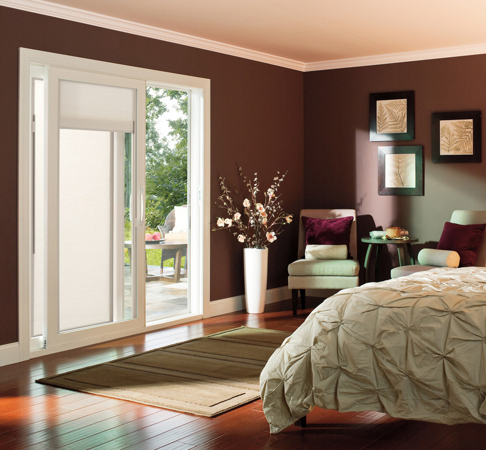 Design ideas for a large transitional master bedroom in Austin with red walls and dark hardwood floors.