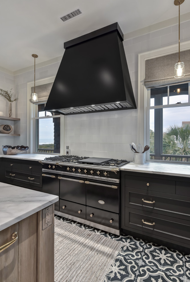 Inspiration for a mid-sized country u-shaped separate kitchen in Charleston with a farmhouse sink, recessed-panel cabinets, black cabinets, marble benchtops, white splashback, subway tile splashback, stainless steel appliances, cement tiles, with island, multi-coloured floor and white benchtop.