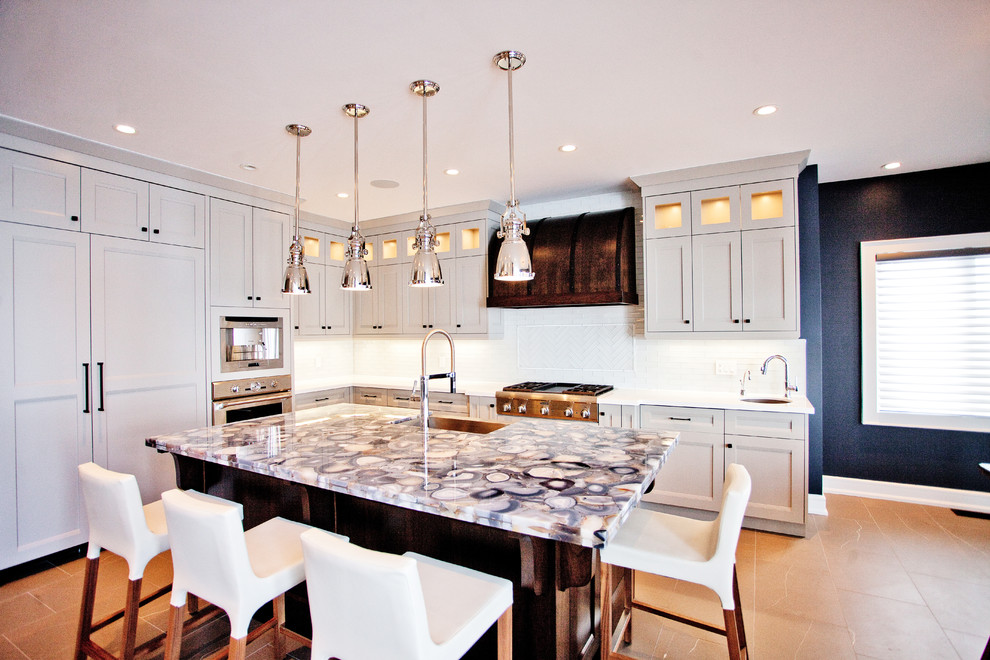 Inspiration for a transitional l-shaped kitchen in Toronto with recessed-panel cabinets, grey cabinets, white splashback and panelled appliances.