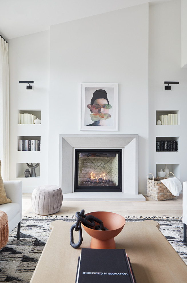 グランドラピッズにある高級な広いコンテンポラリースタイルのおしゃれなLDK (白い壁、淡色無垢フローリング、標準型暖炉、コンクリートの暖炉まわり、三角天井、白い天井) の写真
