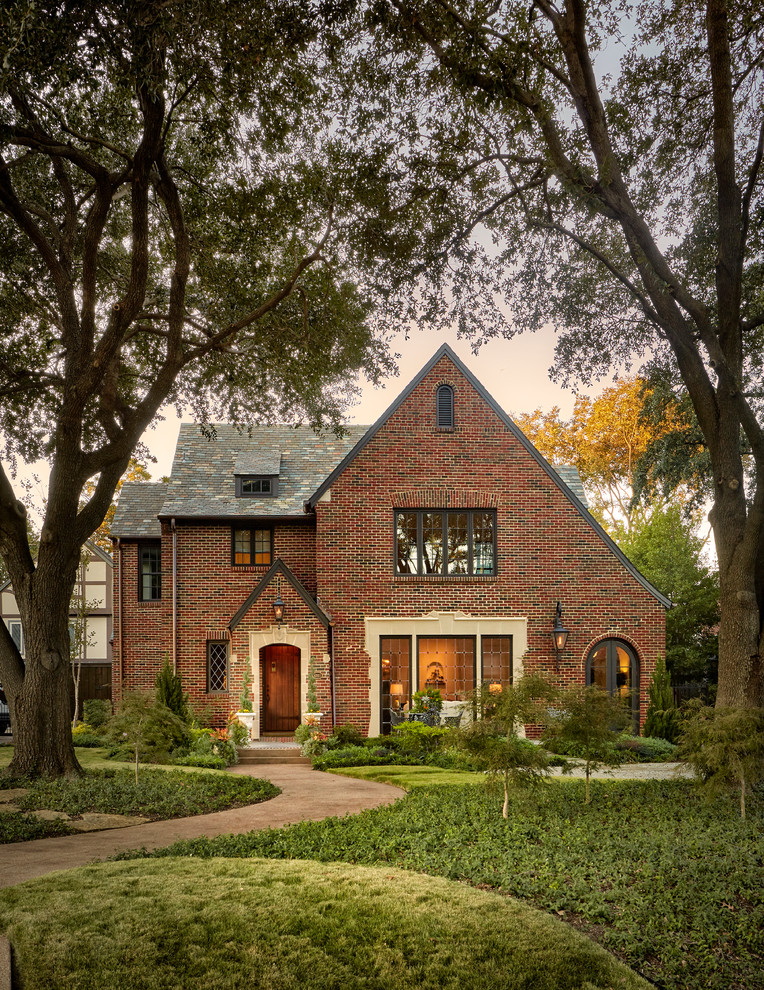 Design ideas for a large traditional three-storey brick red house exterior in Dallas with a gable roof and a shingle roof.
