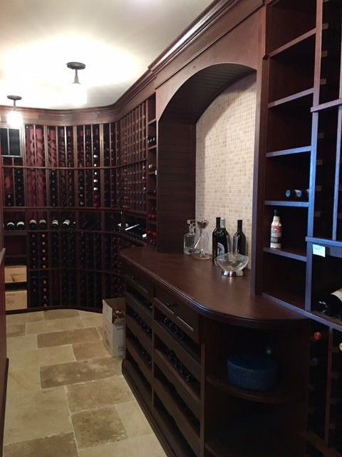 Inspiration for a large traditional wine cellar in Portland Maine with slate floors, storage racks and beige floor.