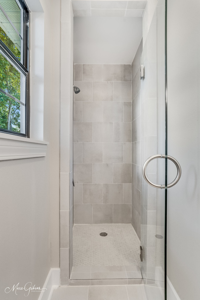 This is an example of a small contemporary master bathroom in Other with beaded inset cabinets, blue cabinets, an alcove shower, gray tile, porcelain tile, beige walls, porcelain floors, an undermount sink, granite benchtops, grey floor, a hinged shower door and brown benchtops.