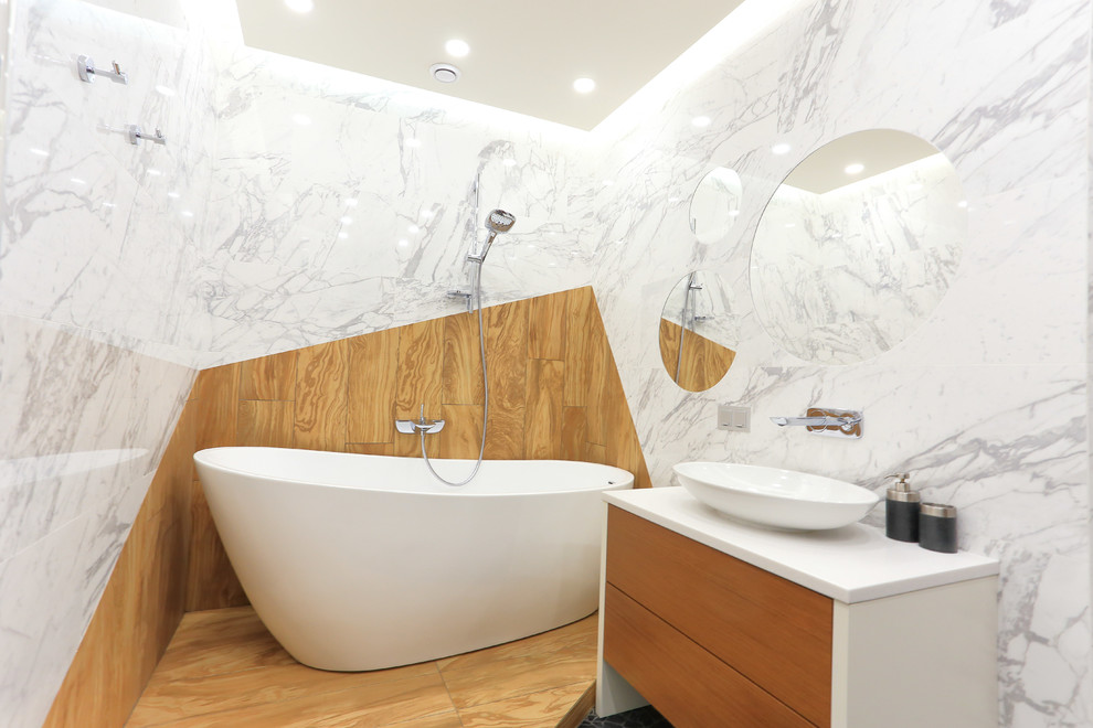 Свежая идея для дизайна: главная ванная комната в современном стиле с отдельно стоящей ванной, инсталляцией, керамогранитной плиткой, полом из керамогранита, накладной раковиной и столешницей из искусственного камня - отличное фото интерьера