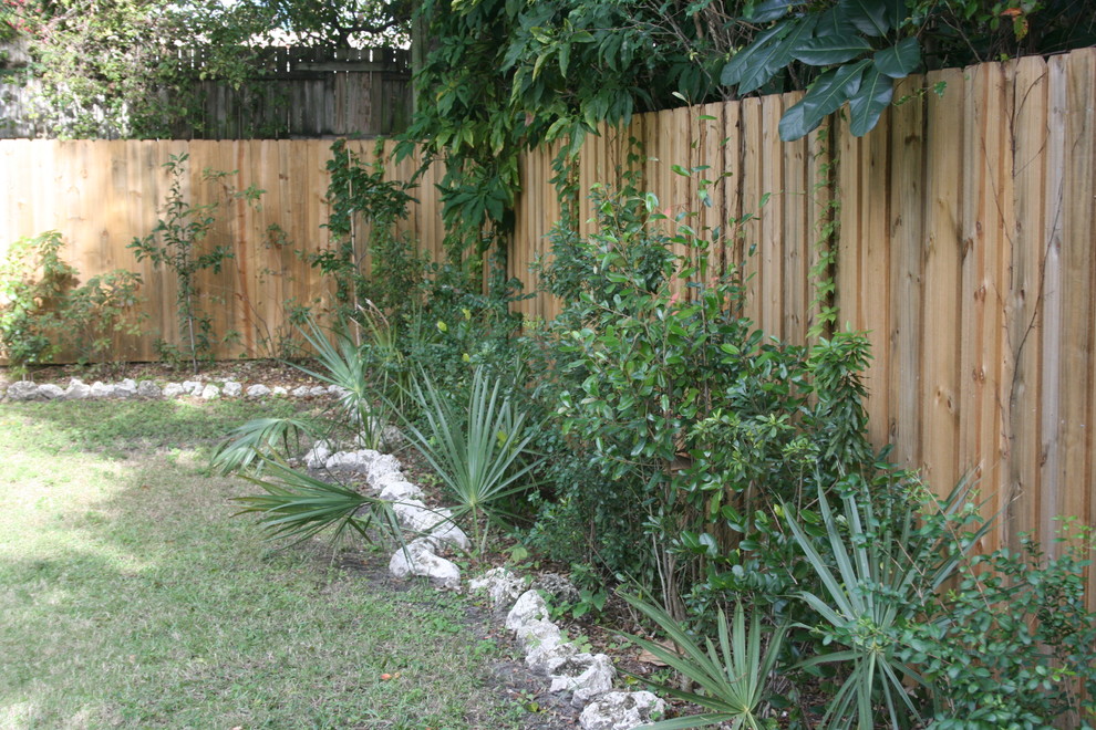 This is an example of a small tropical backyard shaded garden in Miami.