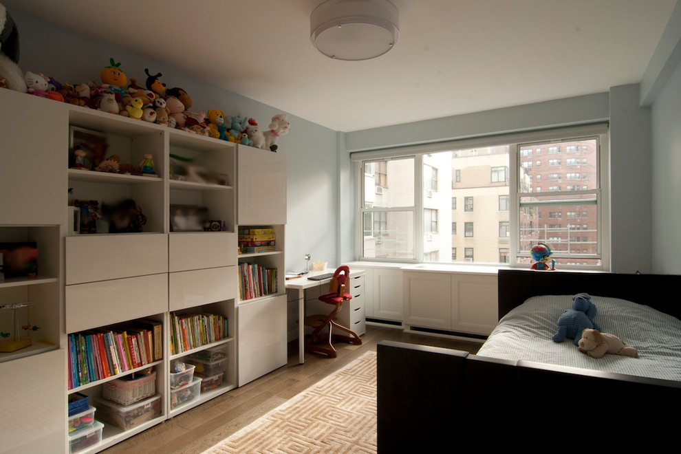 Inspiration for a mid-sized contemporary gender-neutral kids' bedroom for kids 4-10 years old in New York with medium hardwood floors, blue walls and brown floor.