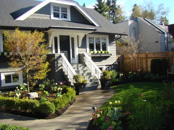 This is an example of a mid-sized traditional front yard partial sun xeriscape in Vancouver with concrete pavers.