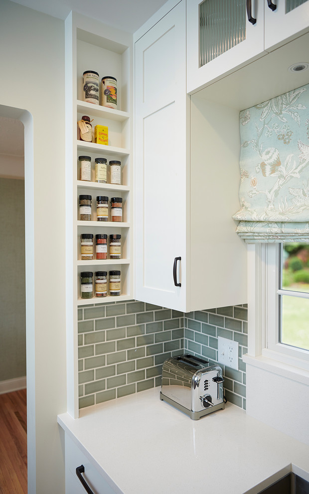 Eat-in kitchen - small transitional u-shaped medium tone wood floor eat-in kitchen idea in Minneapolis with a farmhouse sink, shaker cabinets, white cabinets, quartz countertops, blue backsplash, ceramic backsplash, stainless steel appliances, no island and white countertops