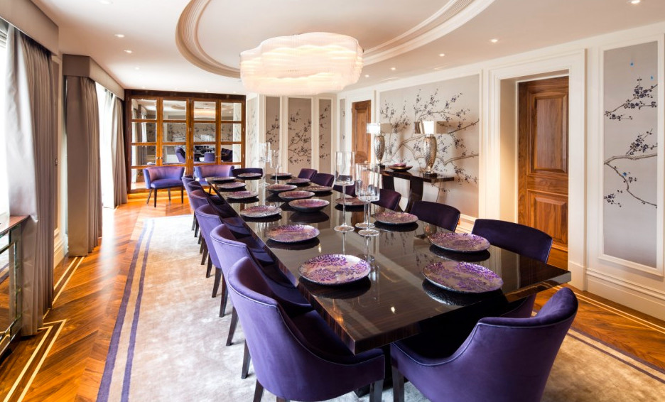 Expansive contemporary separate dining room in London with white walls and carpet.
