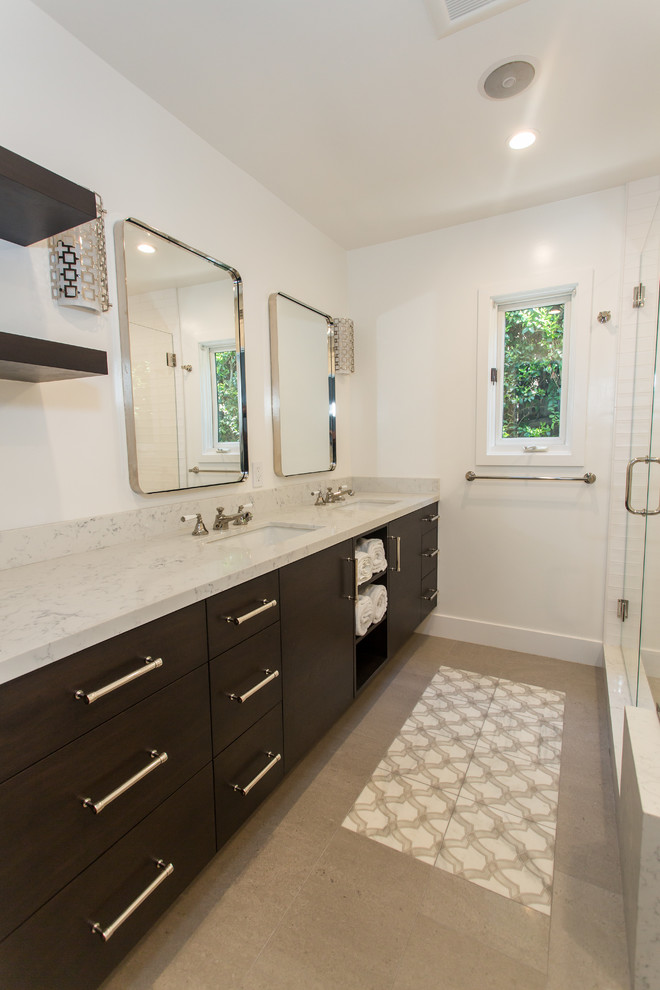 Trendy bathroom photo in Los Angeles with flat-panel cabinets, dark wood cabinets and marble countertops