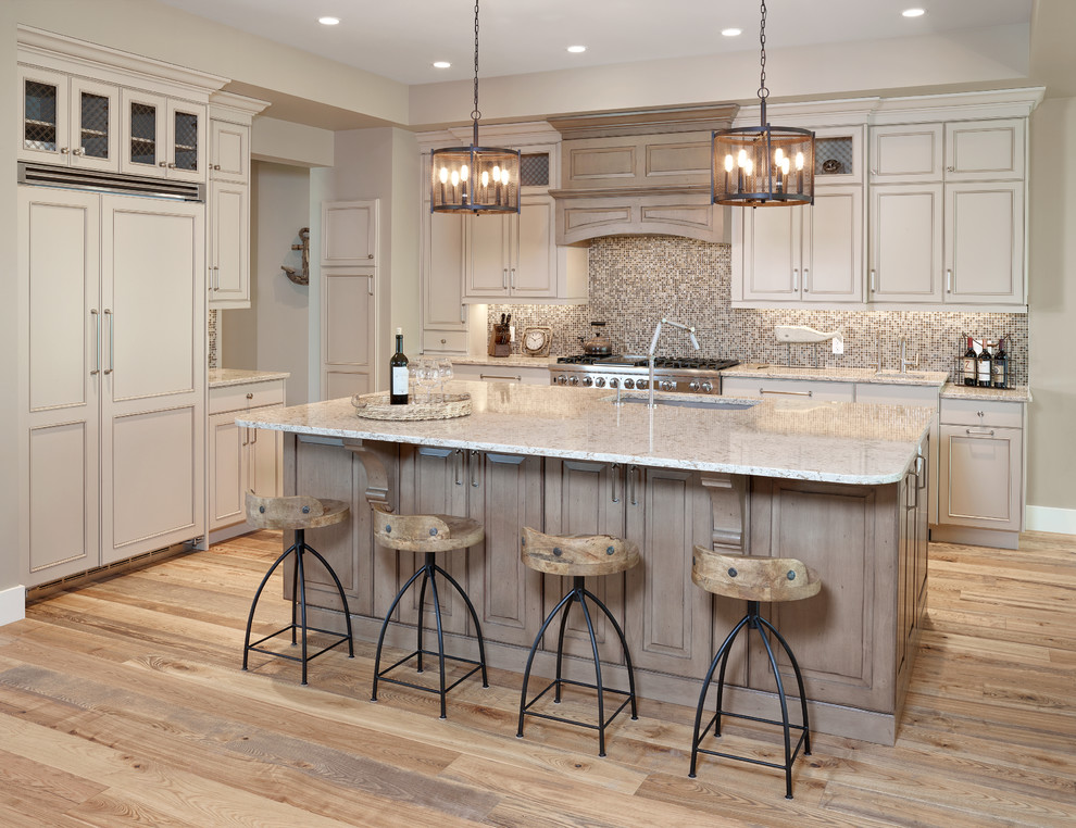 Example of a mid-sized transitional l-shaped medium tone wood floor open concept kitchen design in Edmonton with an undermount sink, quartz countertops, stainless steel appliances and an island