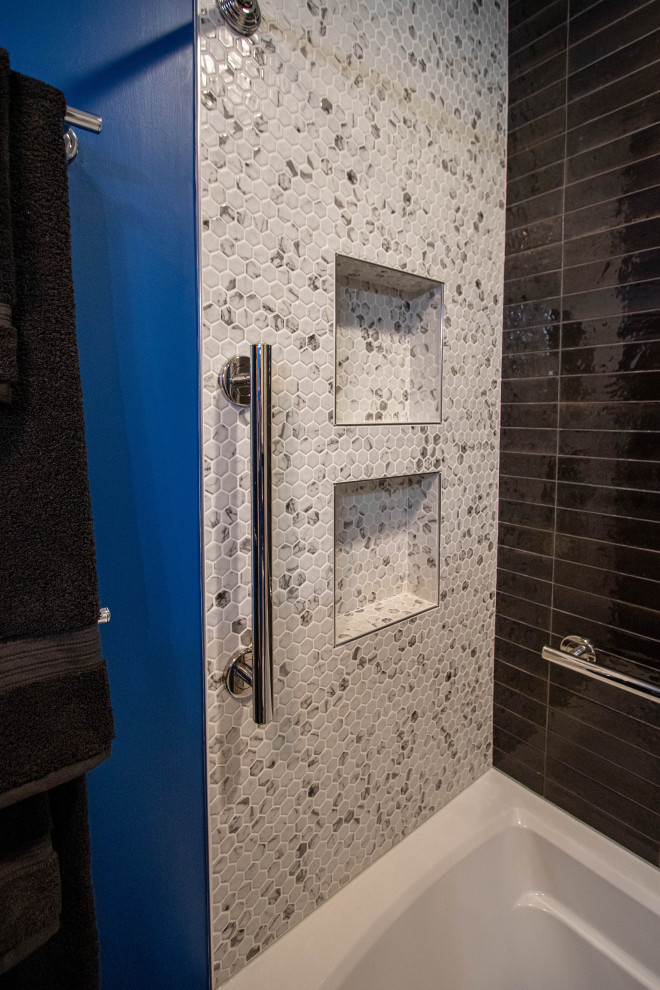Photo of a small classic shower room bathroom in Cleveland with flat-panel cabinets, white cabinets, an alcove bath, a two-piece toilet, black tiles, ceramic tiles, blue walls, ceramic flooring, a submerged sink, engineered stone worktops, grey floors, black worktops, a single sink and a built in vanity unit.
