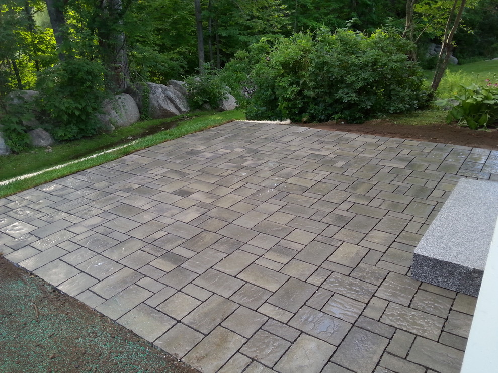 This is an example of a small traditional backyard patio in Boston with concrete pavers and no cover.