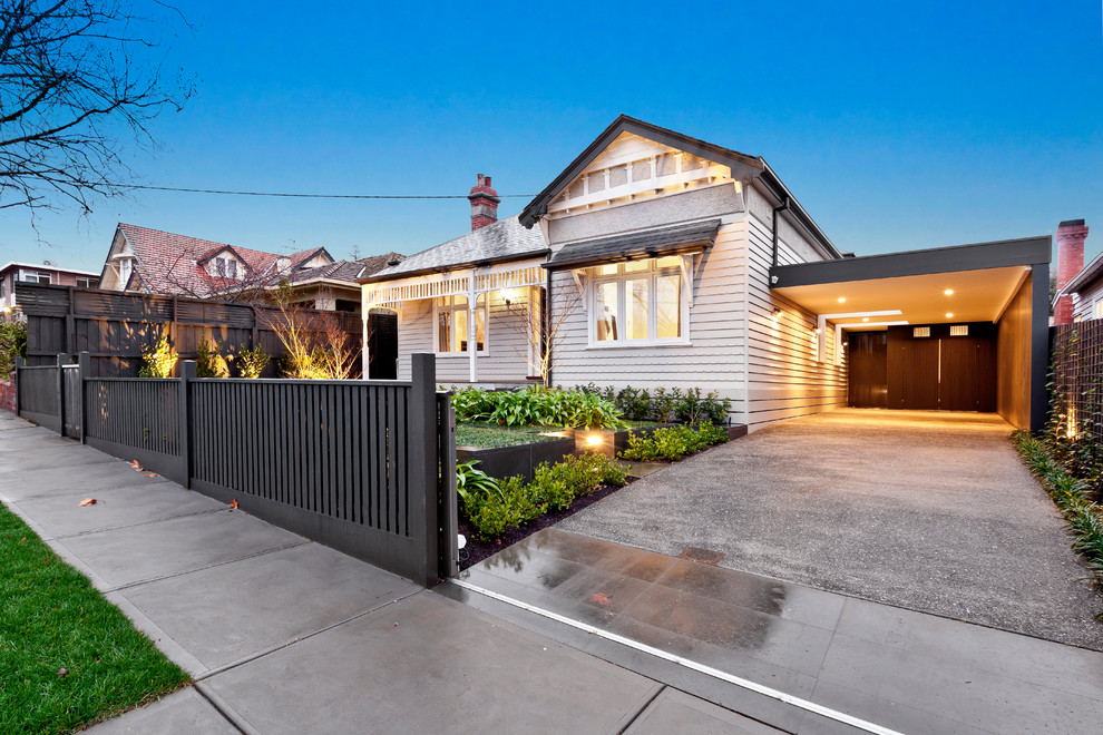 This is an example of a transitional two-storey white house exterior in Melbourne with wood siding and a mixed roof.