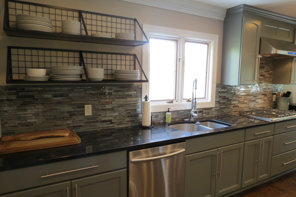 Large transitional dark wood floor and brown floor kitchen photo with a double-bowl sink, recessed-panel cabinets, gray cabinets, granite countertops, multicolored backsplash, stone tile backsplash, stainless steel appliances and two islands